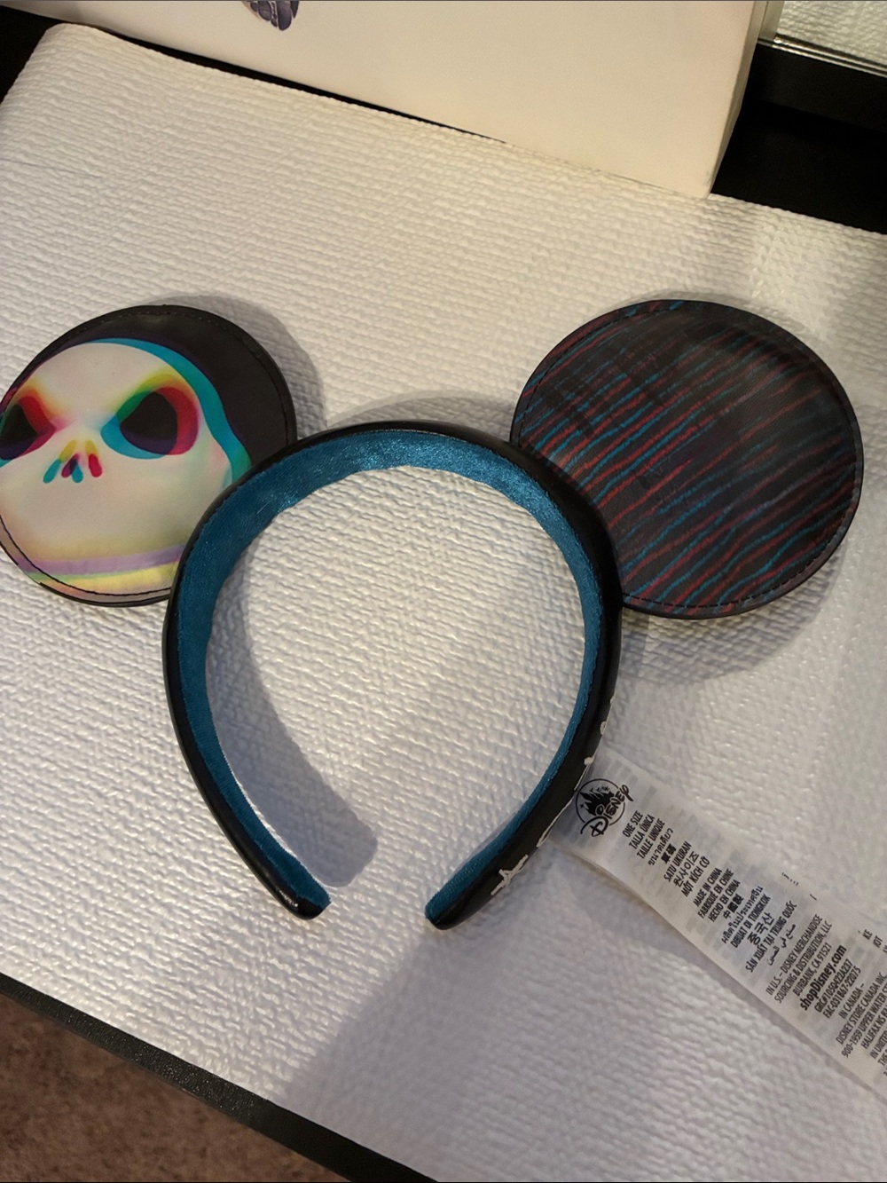 Disney Black Headband with Teal Lining and Multicolor Skull Ears